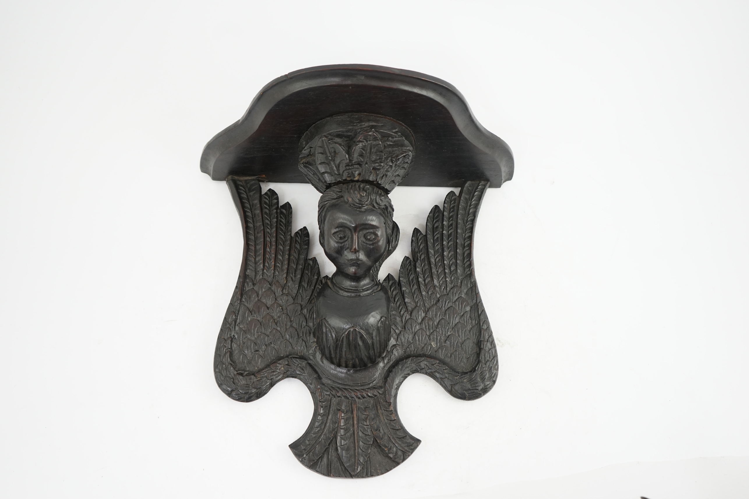 A 17th century style ebonised oak wall bracket